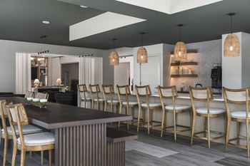 A modern kitchen with a dining table and chairs.